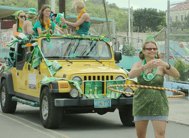 St. John resident Lori Walden spins a hoop as part of the parade.