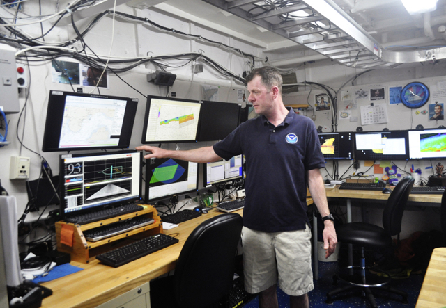 NOAA Oceanographer Tim Battista explains seafloor mapping technology aboard the research ship Nancy Foster.