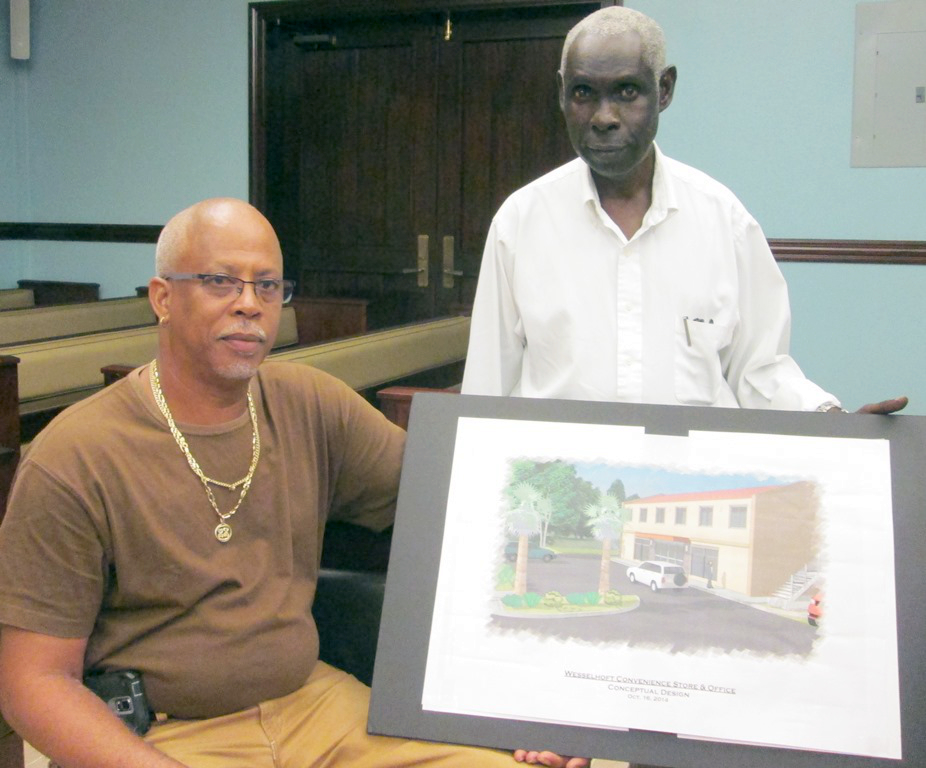 Bernard Wesselhoft and development consultant Brian Turnbull display a drawing of the proposed project.