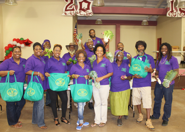 Employees of the family-owned-and-operated Greenridge Guavaberry Farm pose with the produce bags they assembled for the retirees.