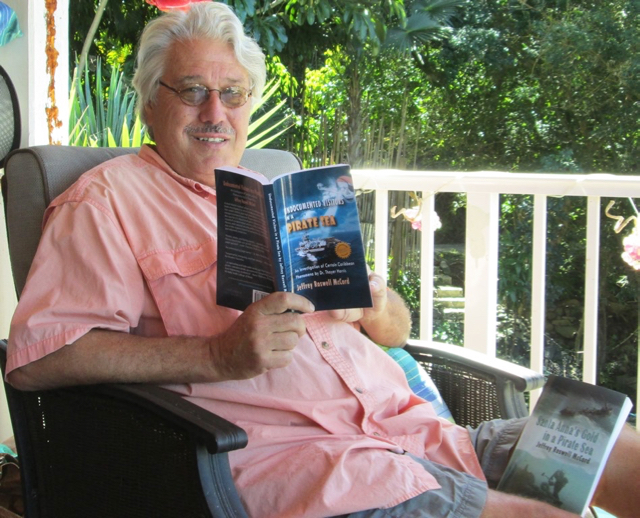 Jeffrey McCord sits on his porch with his new book.