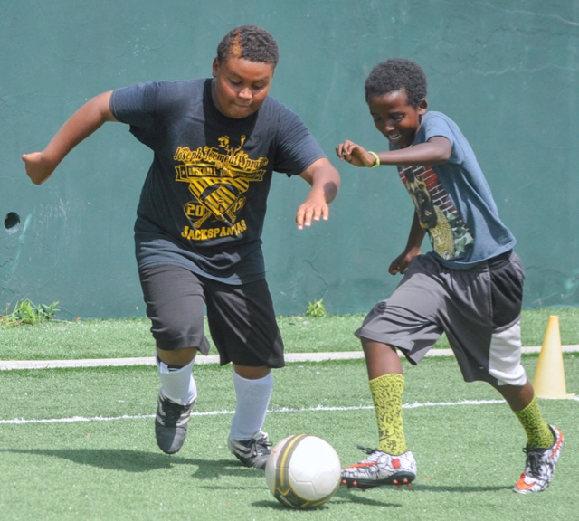 Soccer campers Kassa Bridgewater and Eleto Skahill compete in a drilling exercise.