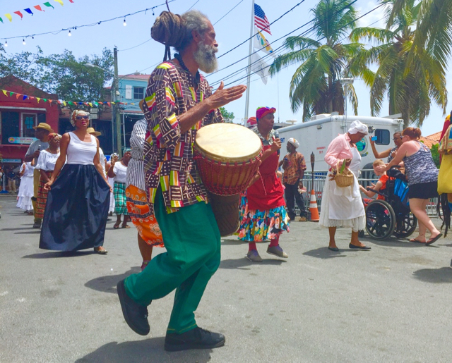 Delroy 'Ital' Anthony, one of St. John Festival 2016&rsquo;s honorees, drums as he leads a procession of actors in 'Set the Record Straight.'