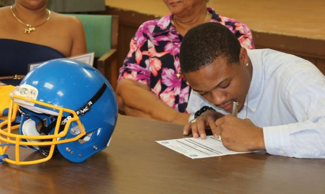 Terrik Grosvenor inks his letter of intent Sunday.