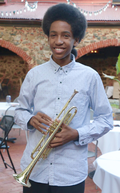Keyshawn Hardy, the leader and youngest member of the Virgin Island Youth Ensemble, posing with the Jerry Silverberg Trumpet Award he recently received. (Photo provided by Branford Parker)