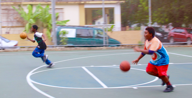 Kassa Bridgewater and Enrique Royer compete in a dribbling competition during Sunday's Unified Hoops Galore event.