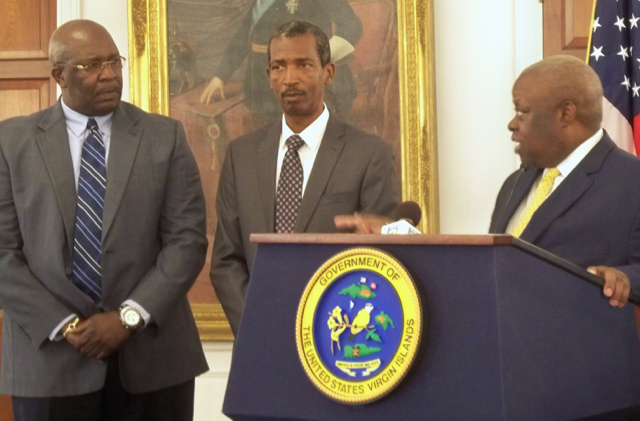 Gov. Kenneth Mapp, right, talks to Dennis Brow as Gustave James stands between them.