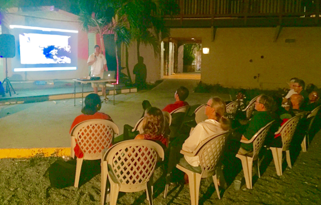 UVI coral reef ecologist Tyler Smith talks about ciguatera on the Christiansted boardwalk Friday night.