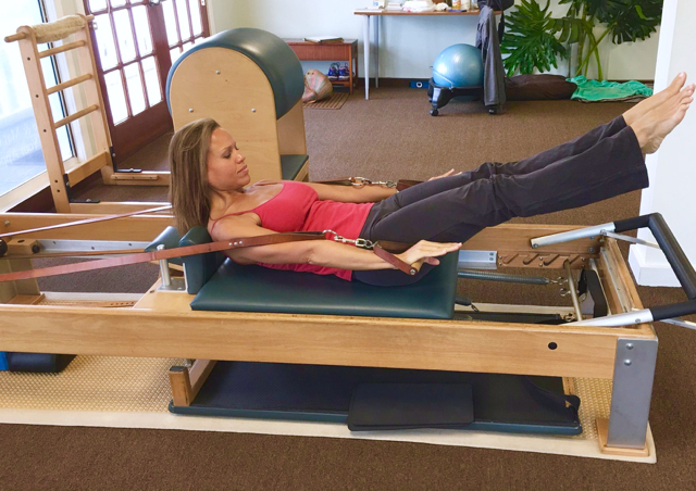 Lutarek demonstrated a classic Pilates exercise on 'the Reformer.'