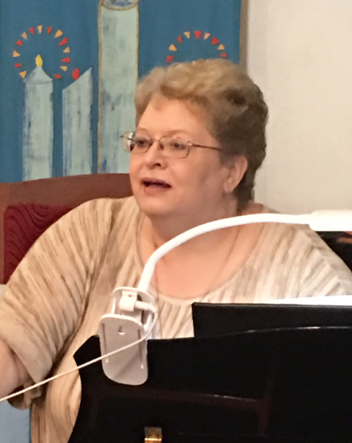Director Janice Ballard listens during a choir practice.