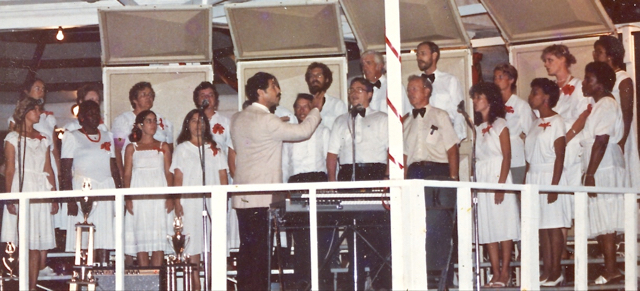 In 1986, John Cahill directs the St. John Singers in Emancipation Garden.