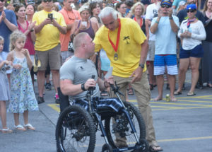 8 Tuff Miles organizer Peter Alter congratulates Travis Strong, the first person ever to complete the race using a handcycle.