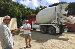 Cook and Buttermore look at one of their cement trucks, which were specially designed to handle St. John's steep grades.