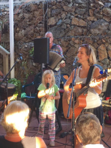 Co-host Lauren Magnie and her daughter, Elena, perform with the band at the Cafe Concordia.