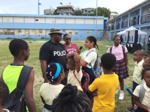 Students ask Officer Ecedro Lindquist questions following the demonstration during National Police Week activities on St. John.