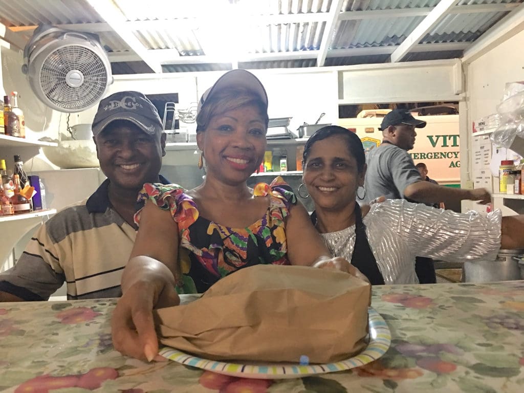 Fitzroy Douglas, Diane Lewis, and Leah Rivière serve roti made by chef Troy Ferguson