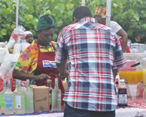 Kish-Ann Duncan serves up food and drink at St. John Festival’s Food Fair. 