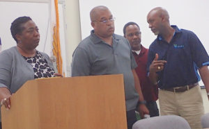 From left, Ann Hanley, wastewater director, Vince Ebbesen, solid waste director, Elvis Pemberton, wastewater manager and Roger E. Merrit, Jr. executive director, listen to questions at Waste Management Authority town hall meeting.
