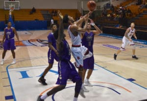 Brock forward Dani Elgadi drives to the hoop through a host of James Madison Dukes.