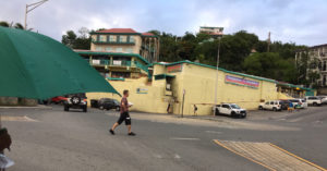 A pedestrian takes a common path to cross the Cruz Bay roundabout.