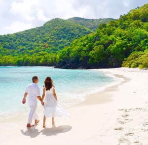 Newlyweds stroll on a St. John beach. (Photo provided by Blueglass Photography)