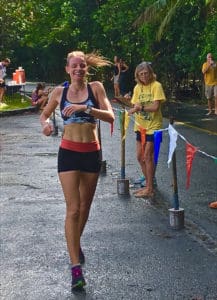 Katrina Lindsay passes the finish line as Lani Clark checks her time.