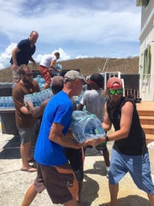 Volunteers unload supplies at the National Park dock.