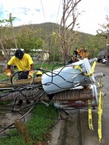 A WAPA lineman works on a downed transformer.