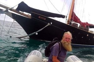 Richard Benson, with his black-hulled ship, Goddess Athena," in the background. (Benson family photo)