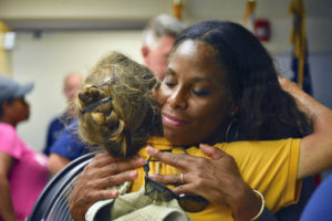 Delegate to Congress Stacey Plaskett embraces a Virgin Islander after the territory was hit by two category five hurricenes. (Photo from Plaskett's offical website)