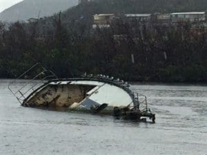 A sunken boat lies int eh water off St. Thomas. It is on of at least 336 sunken vessels recorded int he territory.