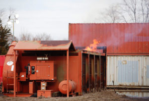 An air curtain incinerator in use at Floyd Bennet Field, Brooklyn, New York, after Hurricane Sandy. (Image from "Notice of Intent to File Suit" from the Environmental and Natural Resources Law Clinic at Vermont Law School.)