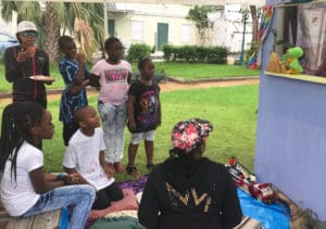 Kids watch a puppet show featuring iggi the iguana at Roosevelt Park Saturday.