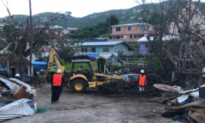 A crew from a Florida-based environmental company clears debris in Frenchtown on St. Thomas. The fate of that debris – whether it is burned or composted – remains unresolved. (Source file photo)
