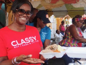 Karen Christian dishes up roast pork, gravy and sides at the Food, Arts and Crafts Fair.