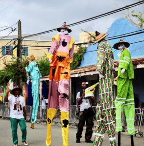 Moko Jumbies dance through Frederiksted with their heads among the power lines. (Anne Salafia photo)