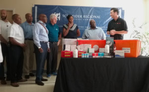 Bill Clinton joins officials from the V.I. Government and Schenider Regional Medical Center as representatives of Direct Relief International, bring four cases of hospital supplies to the hospital.
