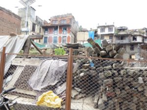 Piles of ancient timber, galvanized and hand carved artifacts await reuse at sacred site in Kathmandu.