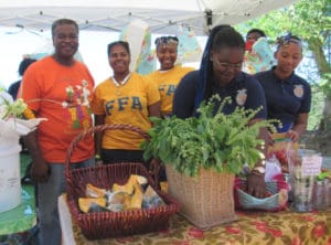 IEKHS Future Farmers of America members present produce and bouquets at their booth, raising funds for a group trip.