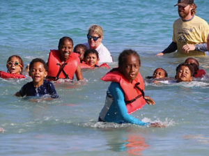 The first set of swimmers, in the 5-to-8 age group, heads for the shore.