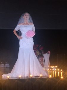 A model dressed in a wedding gown provided by V.I. Bridal and Tuxedo.