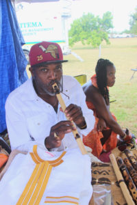 Sneferu Hotep plays a handmade flute he crafted for his “We Shoot Flutes” peace initiative.