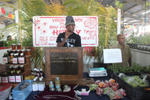 Roniel Allembert II keeps beekeeping in the family by assisting his father known as the “V.I. Honeyman” with his booth.