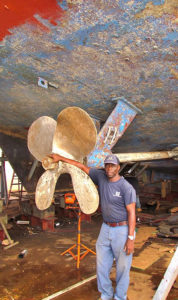 Kenny Layne, shown here underneath a boat, was hired by the shipyard in 1981 and now supervises the welding operation.  (Gerard Sperry photo)