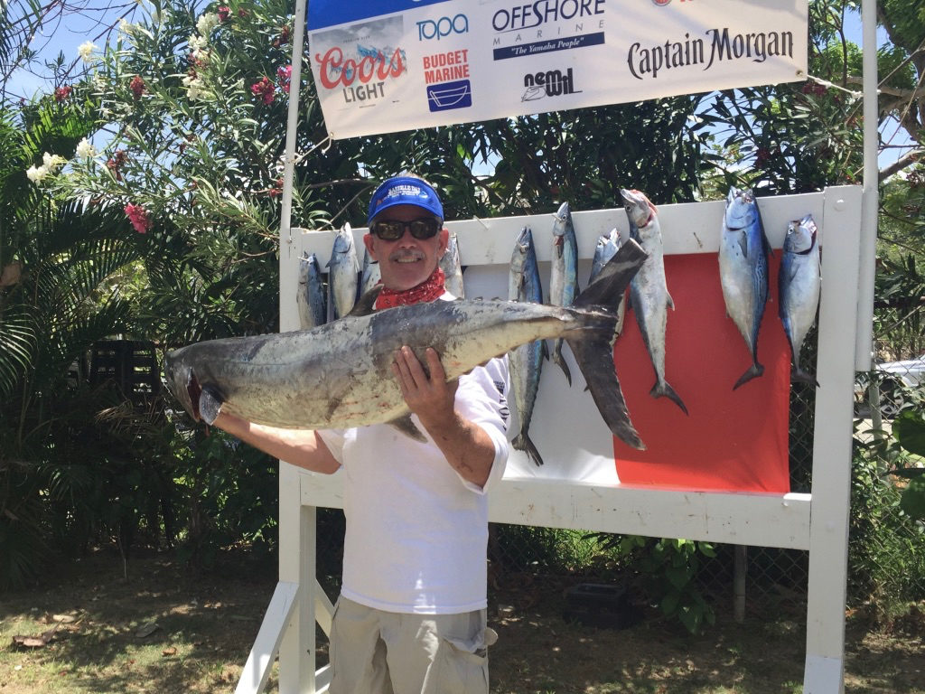 David Stuedell holds up his 45.55-pound kingfish, the winning catch in Sunday's tournament.