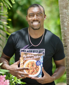 Julius Jackson hlds a copy of his new cookbook, 'My Caribbean Kitchen.' (Gerard Sperry photo)