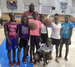 Member of V.I. College Prospects pose with Clint Williams, head coach of the Women’s V.I. national team, after a recent workout at the UVI Sports & Fitness Center.