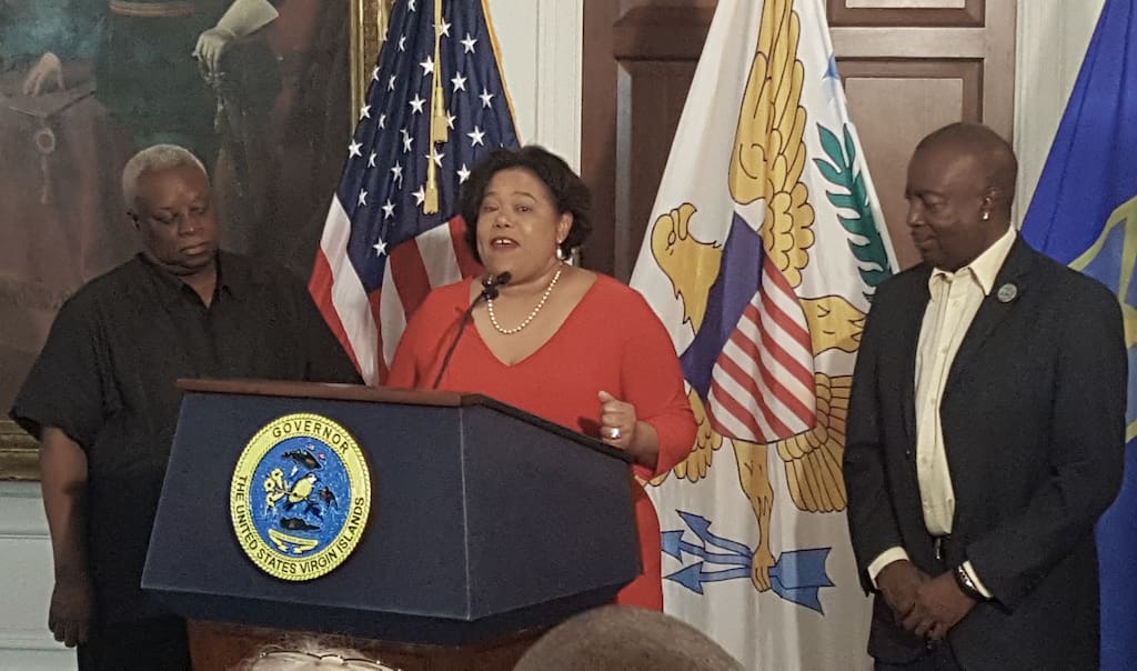Tourism Commissioner Beverly NIcholson-Doty speaks at Tuesday's news conference, flanked by Gov. Kenneth Mapp and Lt. Gov. Osbert Potter.
