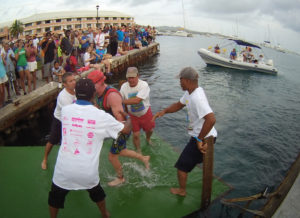 Volunteers help a swimmer out of the water during the 2016 St. Croix Triathlon. (Photo from gotostcroix.com)