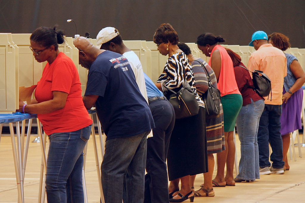 Voters fill rows of privacy booths at the UVI polling site.